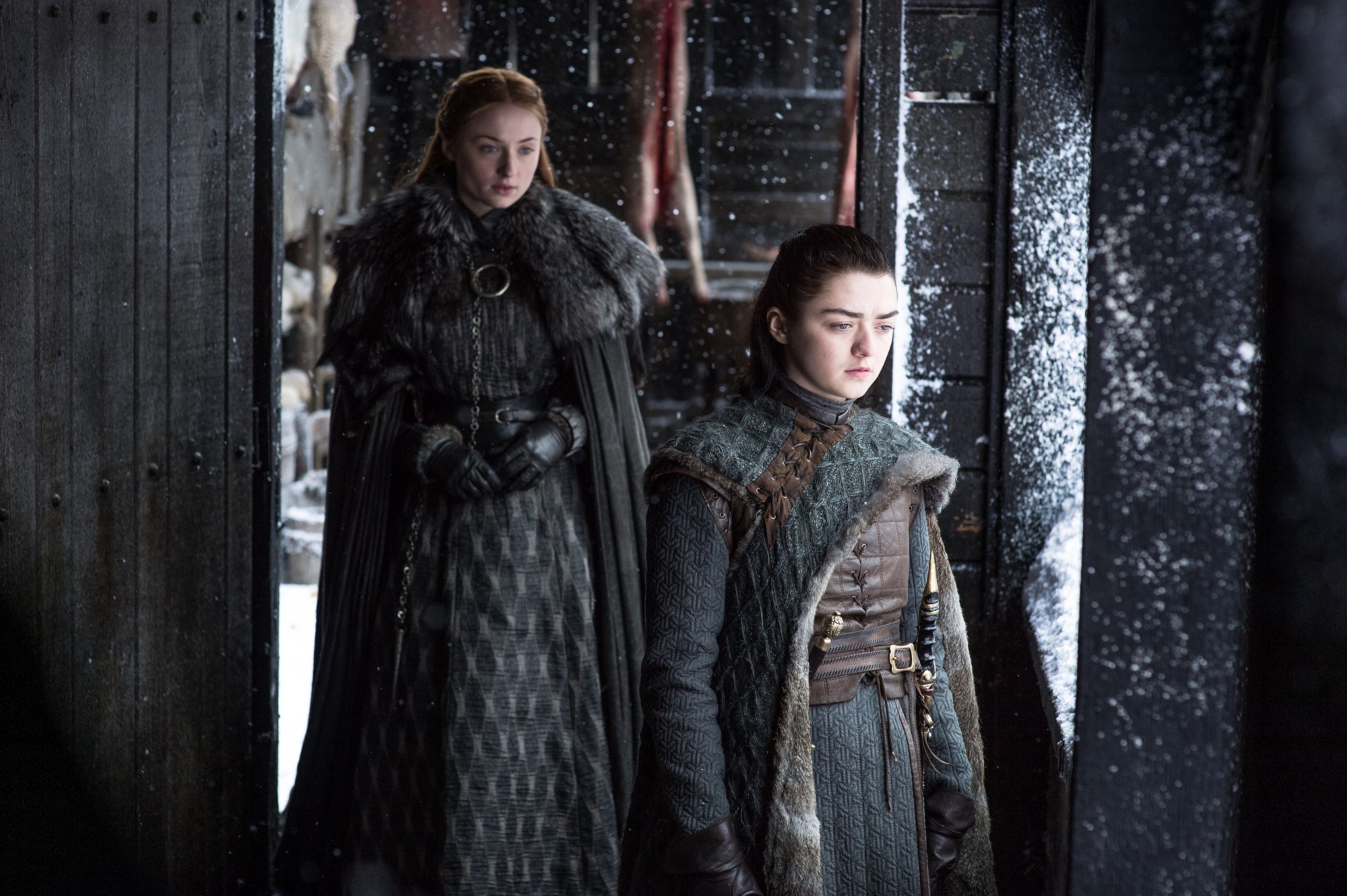 Sophie Turner as Sansa Stark and Maisie Williams as Arya Stark in HBO's Game of Thrones (Credit: Helen Sloan/HBO)
